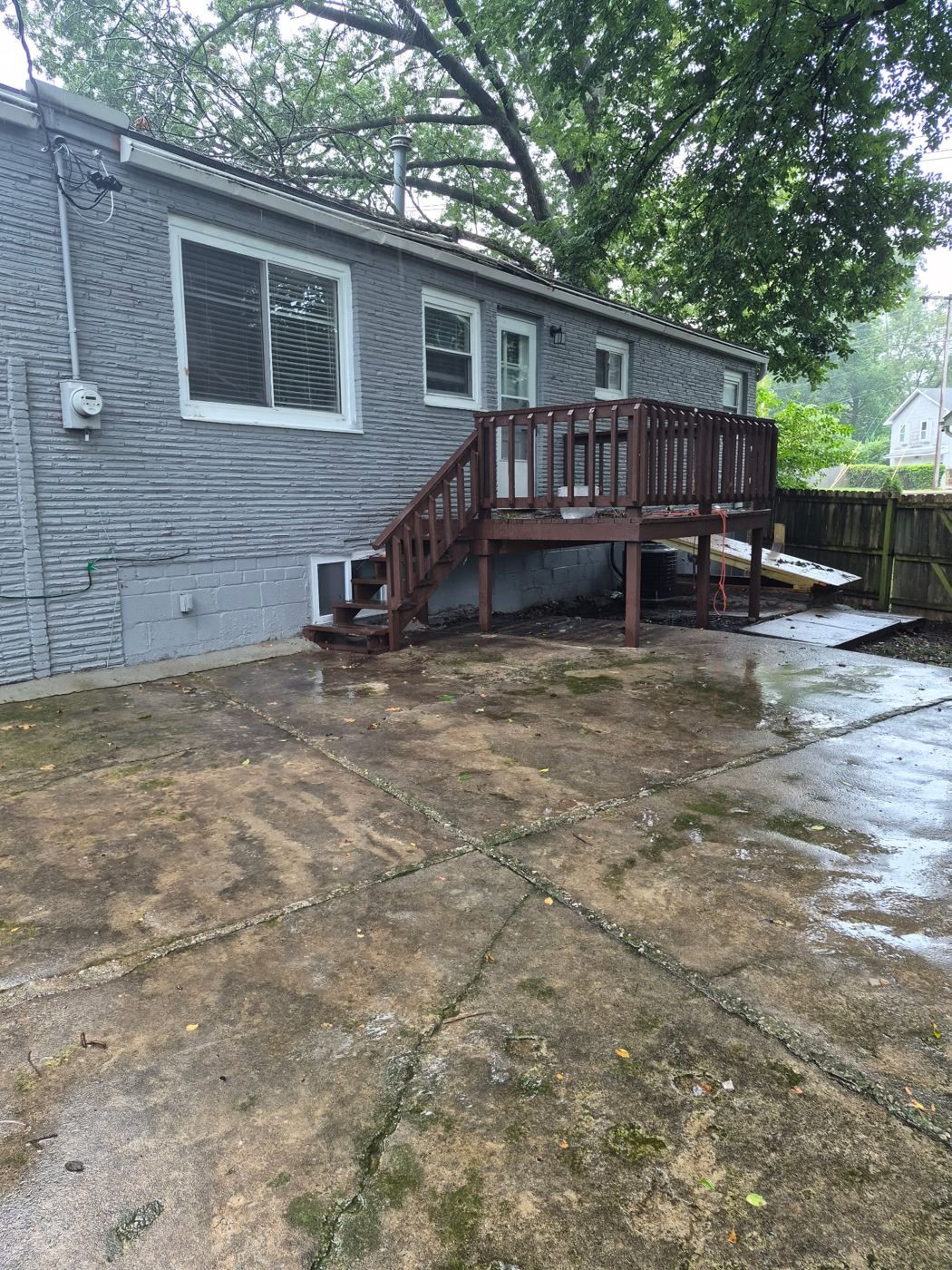 Concrete patio and stairs up to the back deck